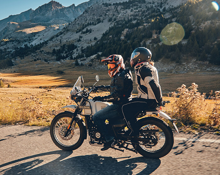 Royal Enfield motorcycle still image on road with 2 riders