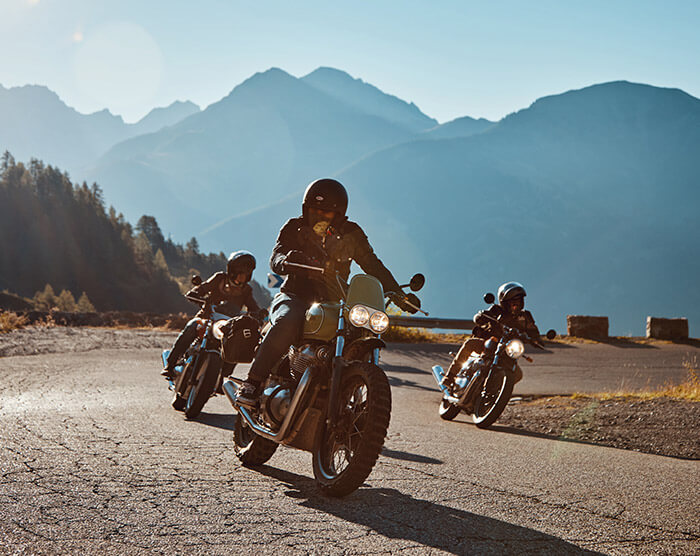 Royal Enfield motorcycle action shot on road with multiple riders