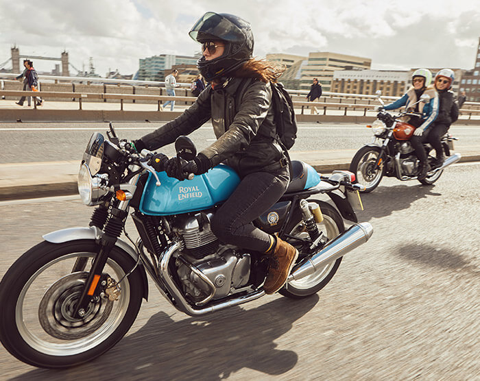 Royal Enfield motorcycle action shot on road with multiple riders