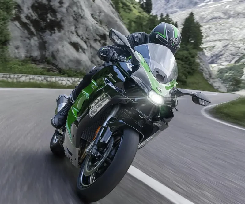 Kawasaki motorcycle action shot on road with Arai helmet in the mountains
