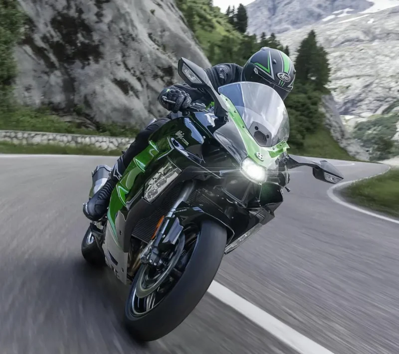 Kawasaki motorcycle action shot on road with Arai helmet in the mountains